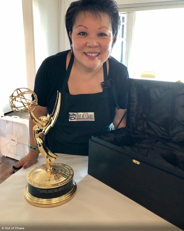 Linda Chu carefully packing an Emmy Award