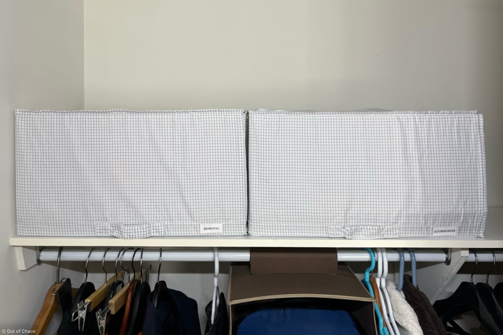 two collapsible storage boxes (IKEA STUK) on a closet shelf