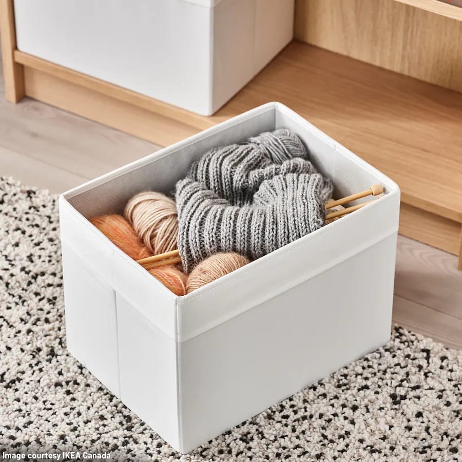 IKEA DROENA collapsible storage bin filled with yarn, knitting needles, and knitting project